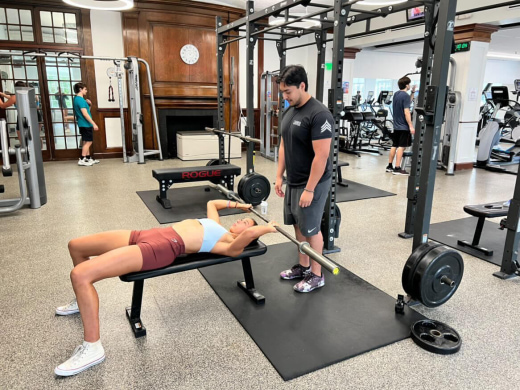 a man and a woman working out in a gym