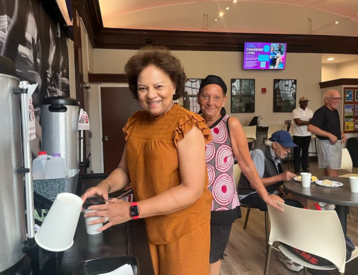 a group of people standing around a coffee shop