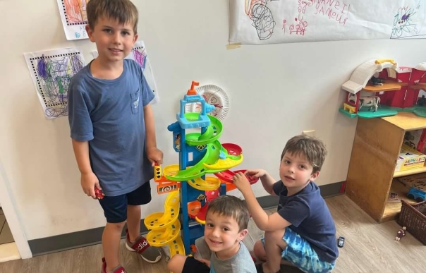 a group of children playing with toys in a room