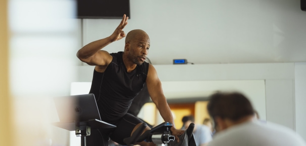 a man riding a stationary bike in a gym