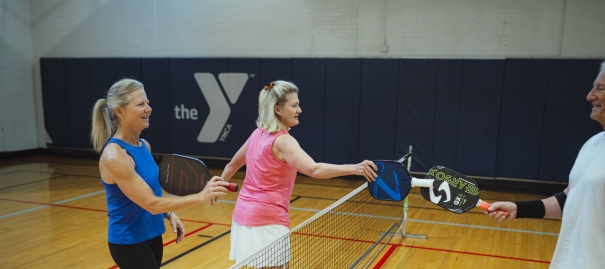 a woman holding a tennis racquet on top of a tennis court