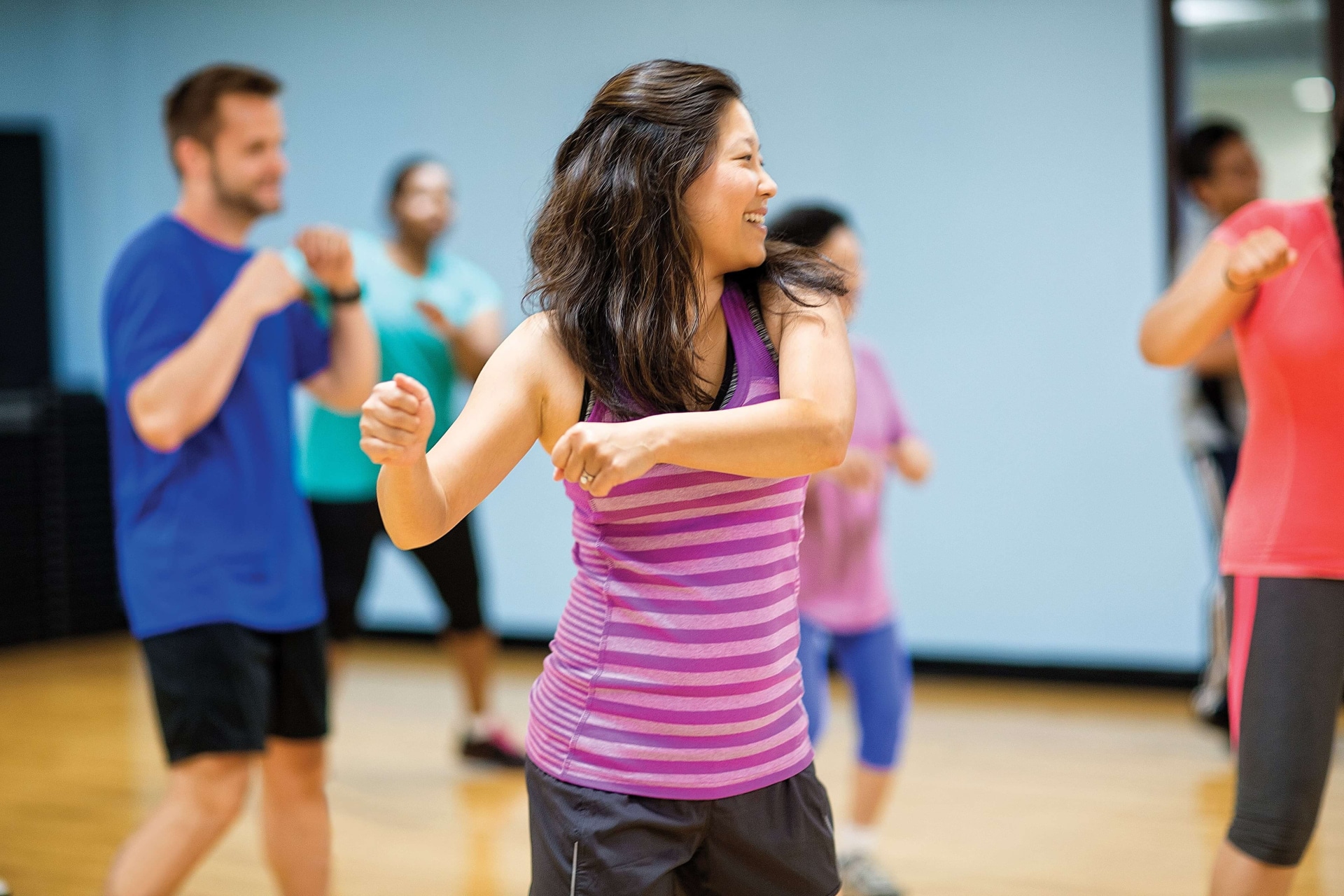 a group of people dancing in a gym