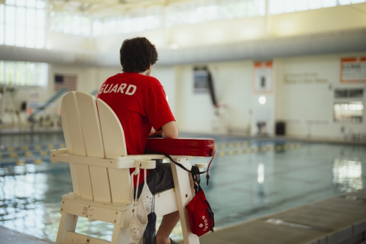 a person sitting on a chair in a swimming pool