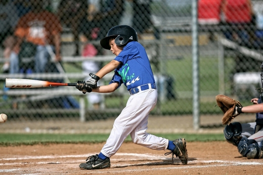 a baseball player swinging a bat at a ball