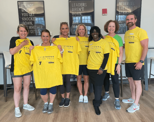 a group of people in yellow shirts posing for a picture