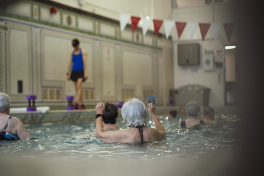 a group of people sitting in a swimming pool