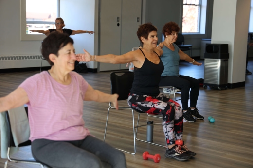 a group of people in a room doing exercises