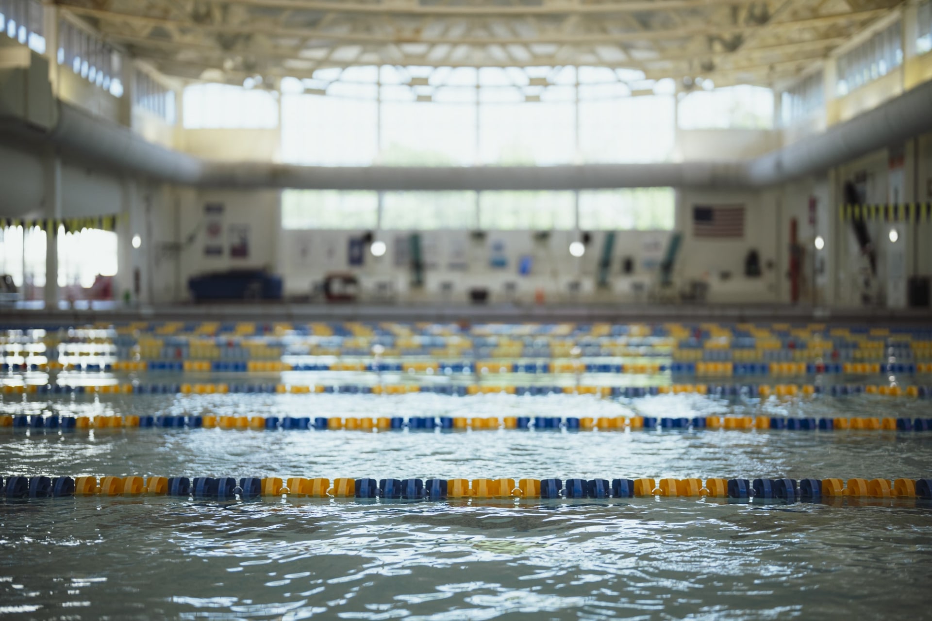 an indoor swimming pool with rows of empty lanes