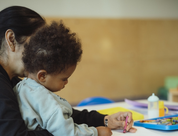 a woman holding a child in her arms