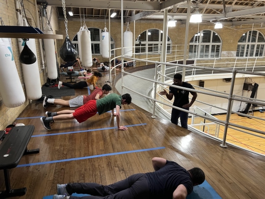 a group of people doing exercises in a gym