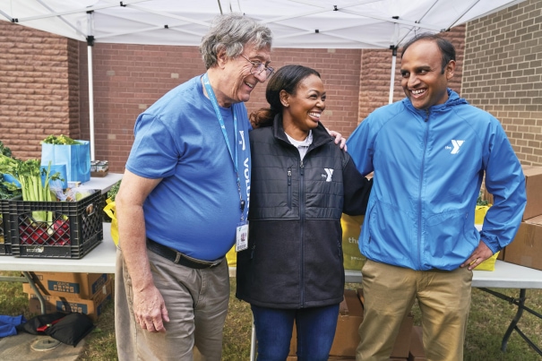 a group of three people standing next to each other
