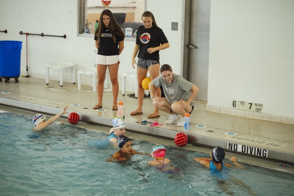 a group of people in a pool image