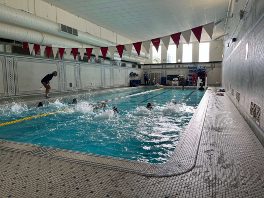 a group of people swimming in a large swimming pool