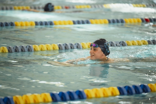 a woman swimming in a pool with a headband on