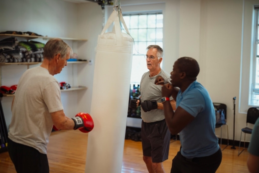 a group of men practicing boxing in a gym