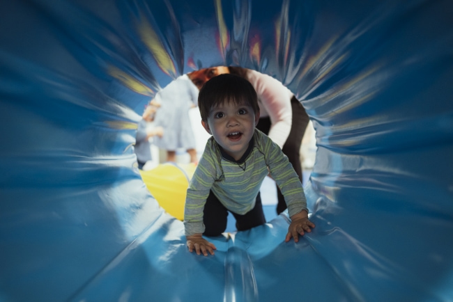 a small child is playing on a slide