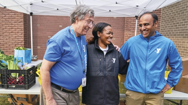 a group of three people standing next to each other