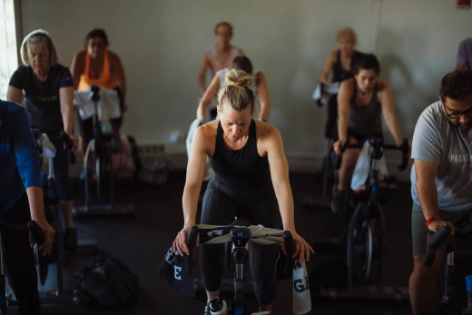 a group of people on exercise bikes